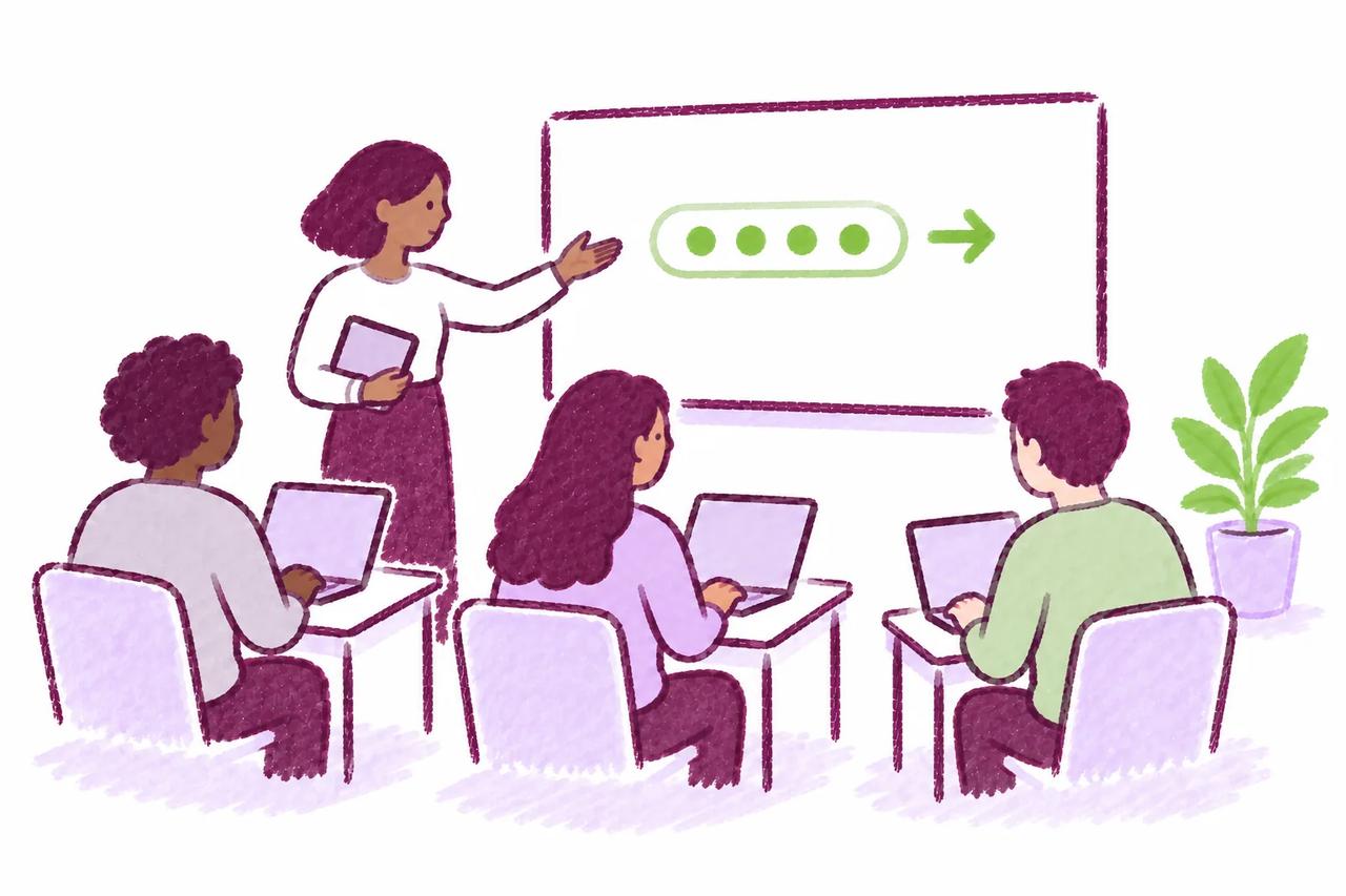 A diverse university class working on laptops with an instructor nearby