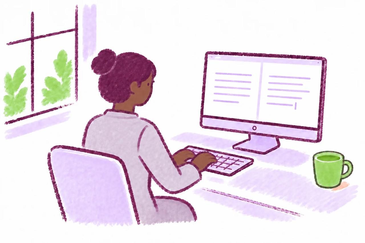 A student writing independently at a computer with a keyboard